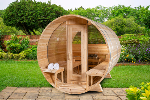 Front view of the Dundalk CT 6-Person Outdoor Barrel Sauna with Half-Moon Windows in a garden