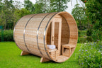 Side view of the Dundalk CT 6-Person Outdoor Barrel Sauna with Half-Moon Windows in a garden