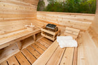 Interior benches with folded towels inside the Dundalk CT 6-Person Outdoor Barrel Sauna with Half-Moon Windows