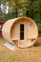Dundalk CT Serenity 5-Person Outdoor Barrel Sauna with autumn leaves