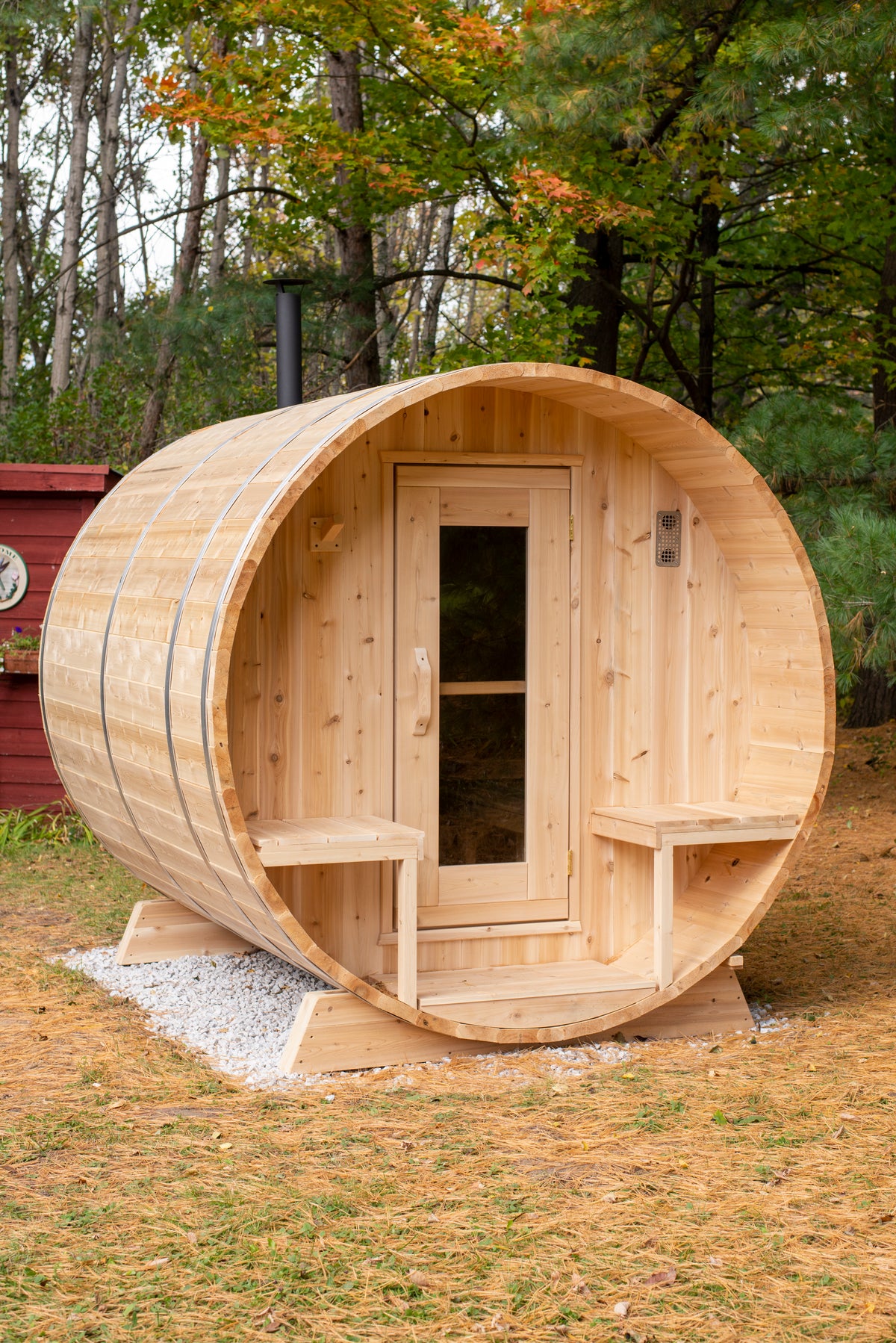 Dundalk CT Serenity 5-Person Outdoor Barrel Sauna with autumn leaves