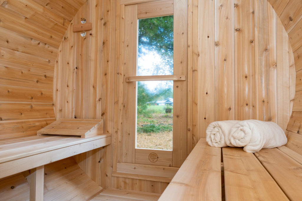 Interior of the Dundalk CT Serenity 5-Person Outdoor Barrel Sauna with window, bench and towels