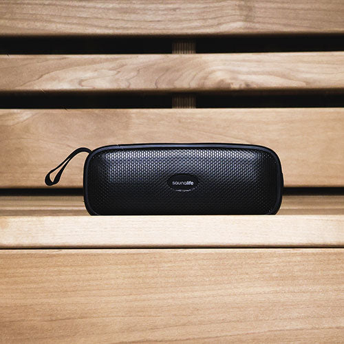 SaunaLife Verse Bluetooth speaker sitting between sauna benches