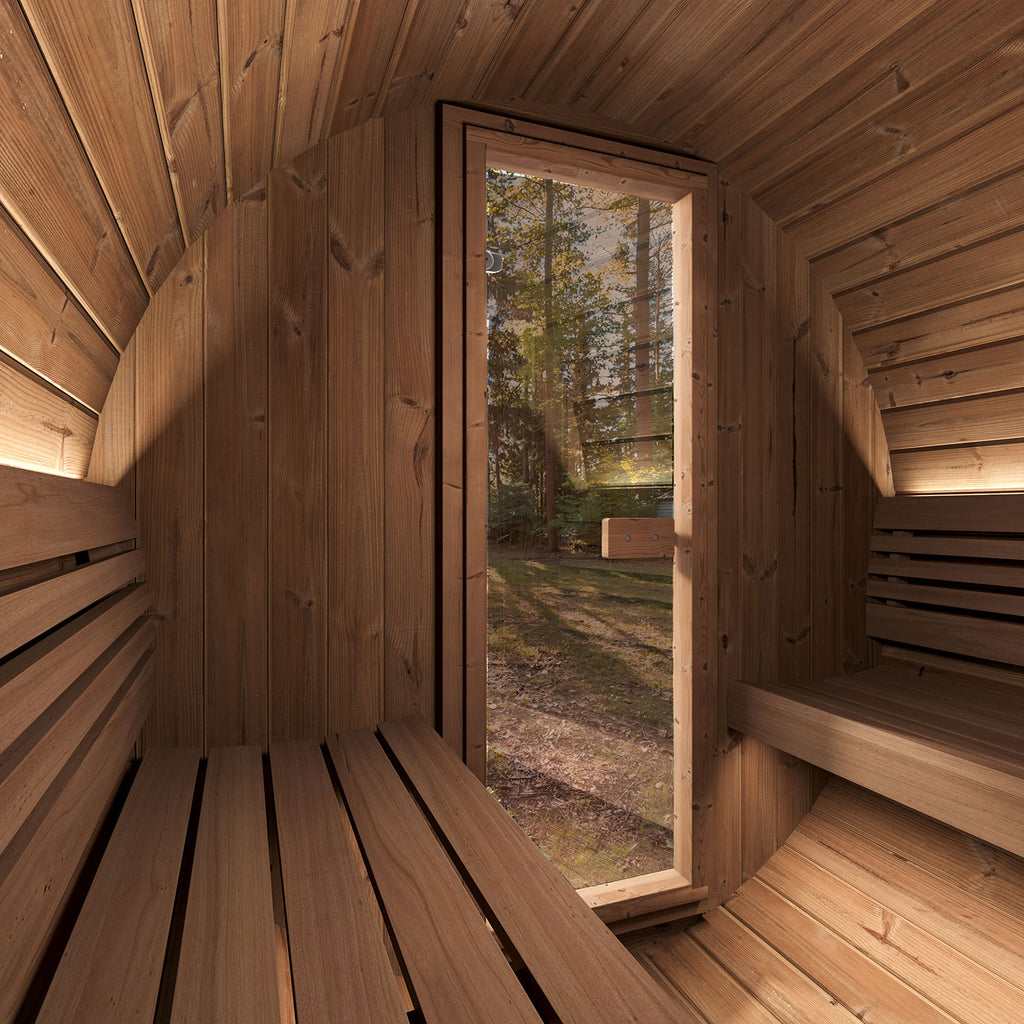 Interior of the SaunaLife E6 Ergo 3-person outdoor barrel sauna looking out through the glass door to trees