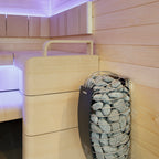 Harvia Spirit 8kW Sauna Heater mounted on a sauna wall beside the bench