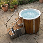 Icetubs IceBarrel XL with stairs on a stone patio